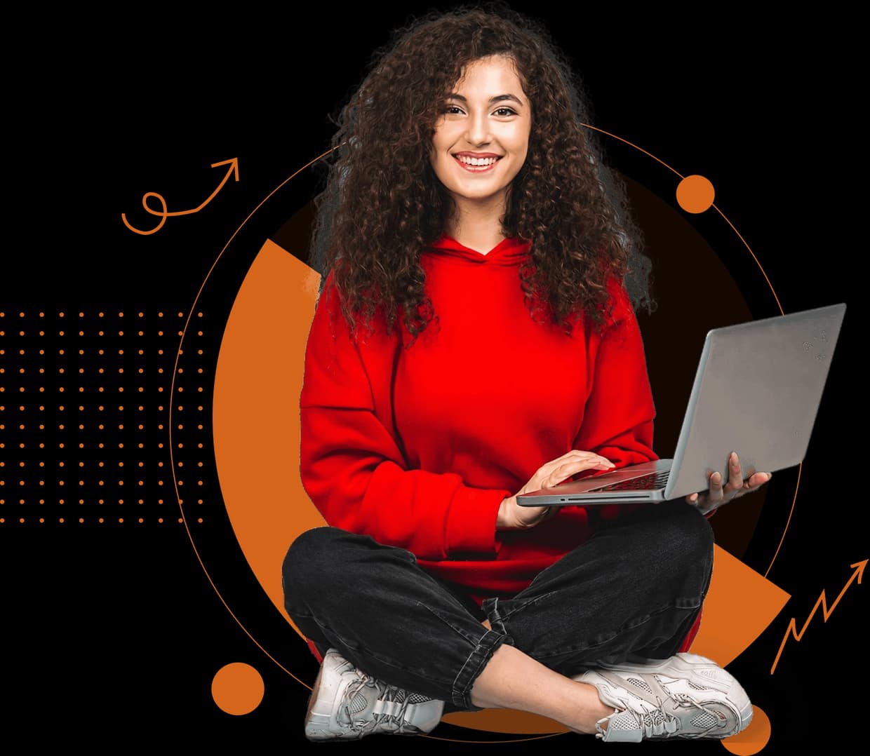 Smiling student sitting cross-legged with a laptop